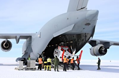 A helicopter being unloaded from the back of a large grey air force plane The helicopters will be used to fly scientists to remote locations in the Bunger Hills region. Photo: Simon Payne