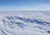 Sastrugi stick out from the snow surface in this photo near Plateau Station in East Antarctica. Most of Antartica looks quite flat, despite the subtle domes, hills, and hollows. Credit: Atsuhiro MutoHigh