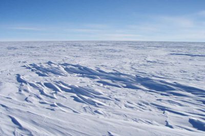 Sastrugi stick out from the snow surface in this photo near Plateau Station in East Antarctica. Most of Antartica looks quite flat, despite the subtle domes, hills, and hollows. Credit: Atsuhiro MutoHigh